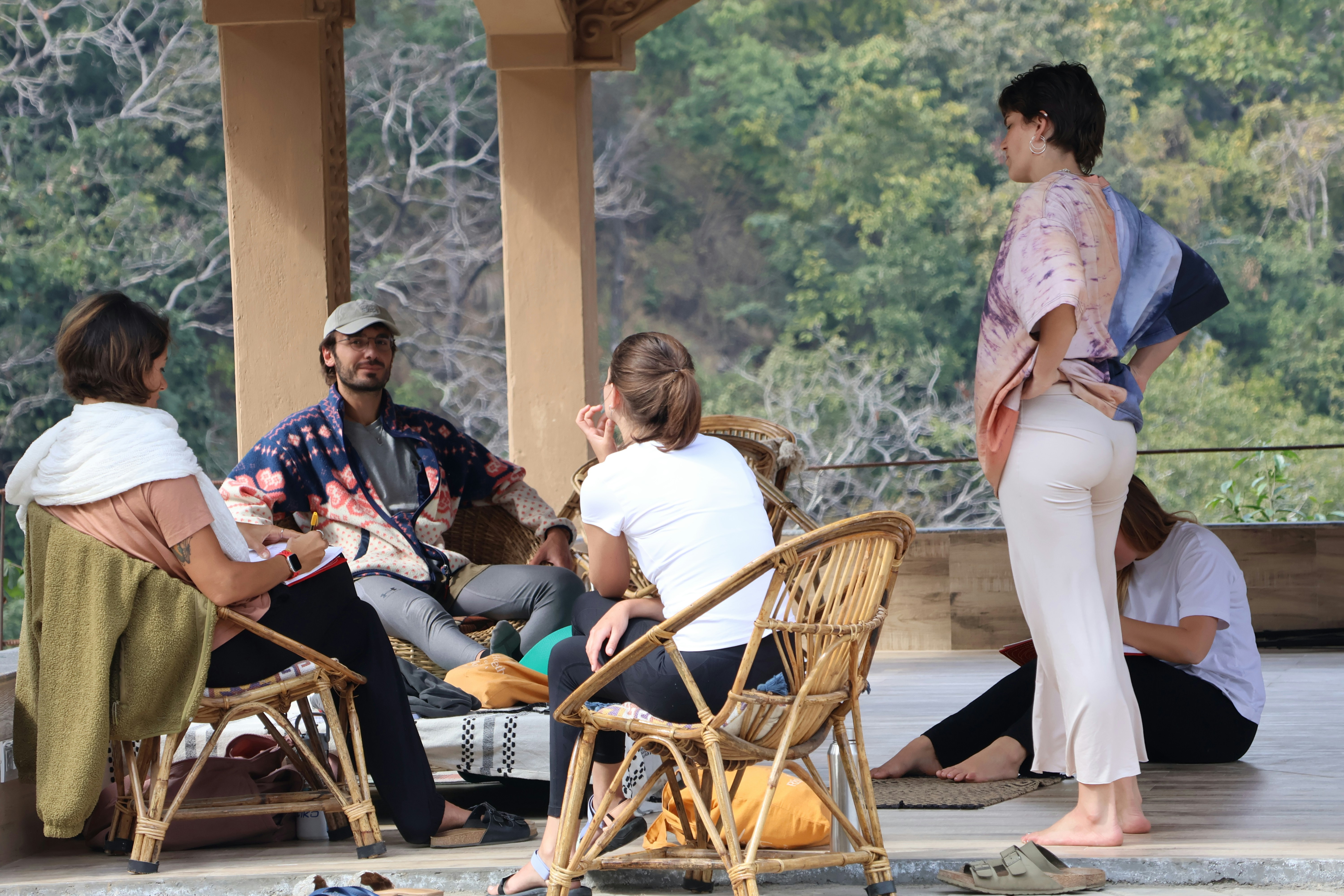 Group of people meditating together in nature at golden hour