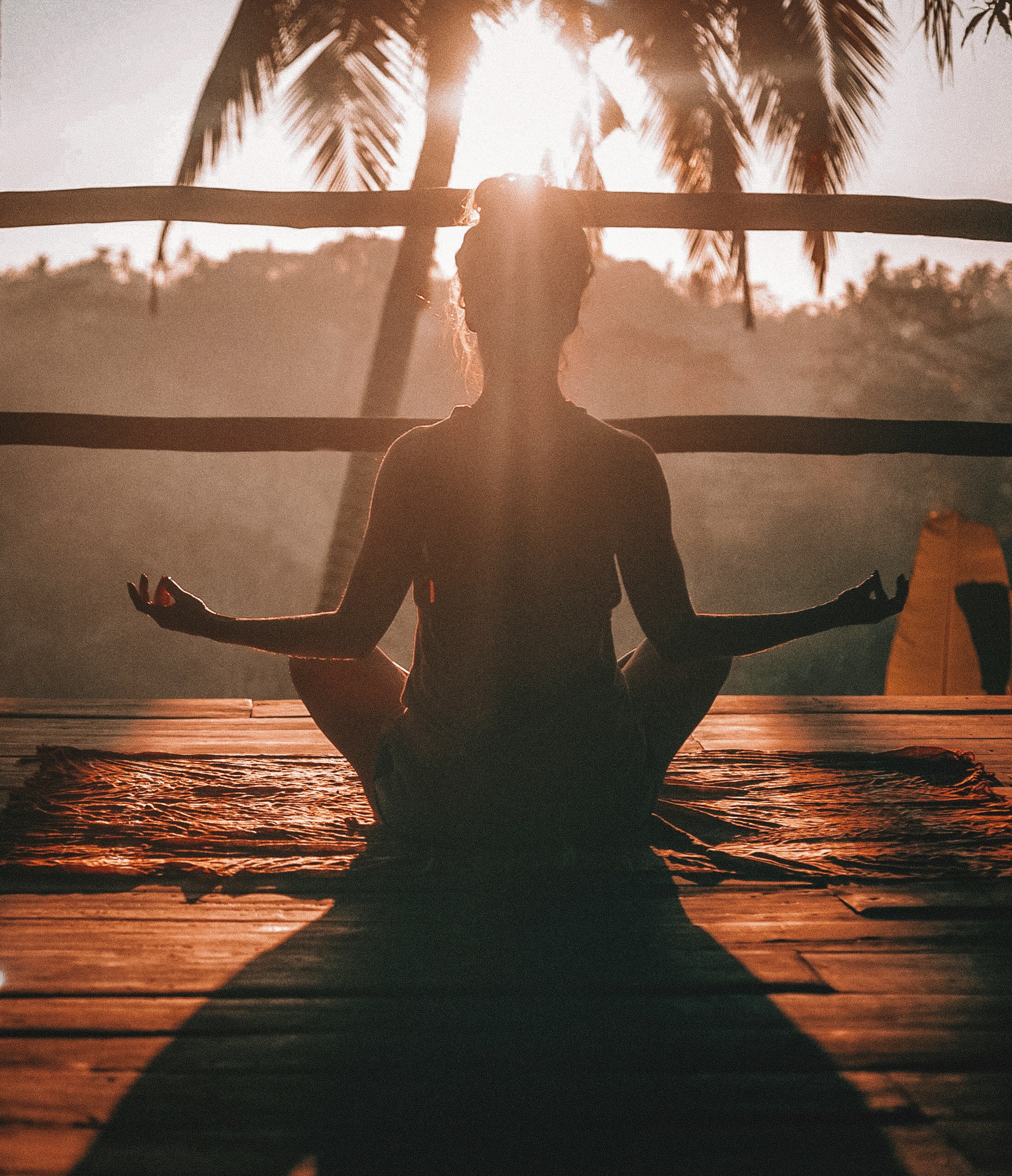 A person meditating peacefully in morning light